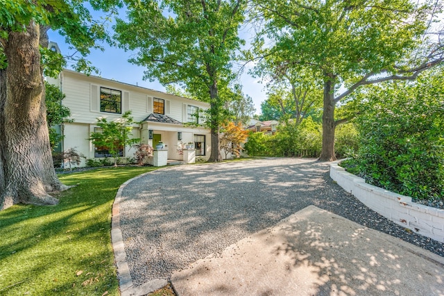 view of property with a garage and a front yard