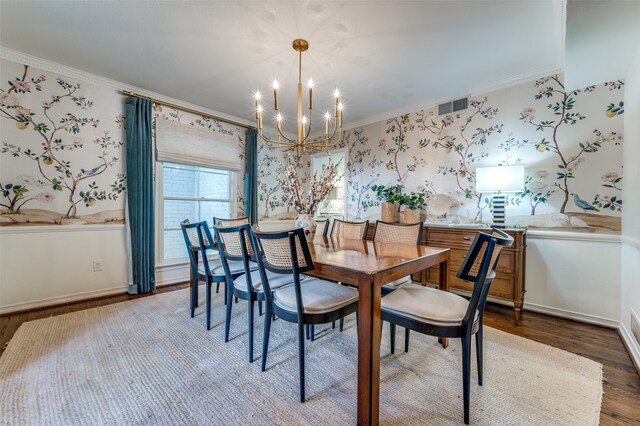 dining area with crown molding, hardwood / wood-style floors, and a chandelier