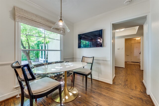 dining space featuring ornamental molding and wood-type flooring