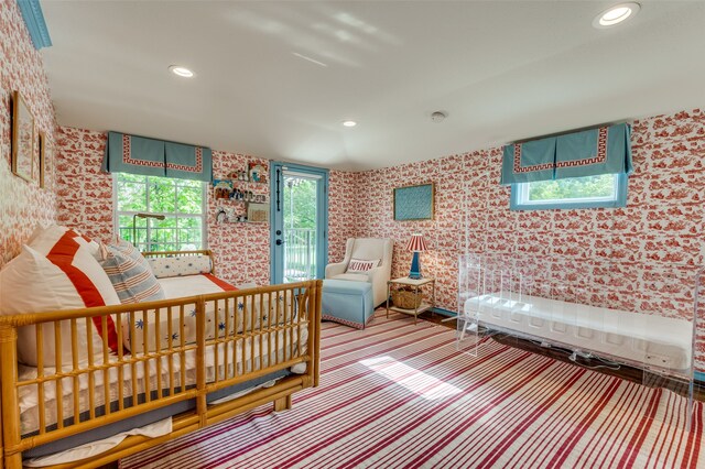 carpeted bedroom featuring multiple windows