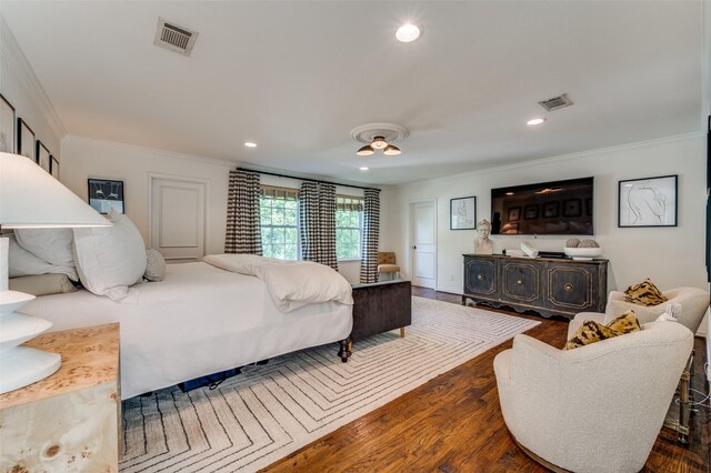 bedroom with crown molding and dark wood-type flooring