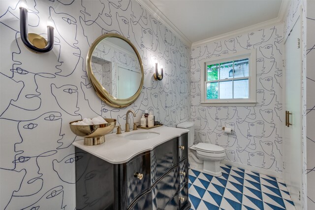 bathroom with crown molding, vanity, and toilet