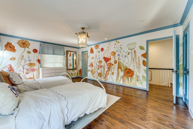 bedroom featuring ornamental molding and hardwood / wood-style floors