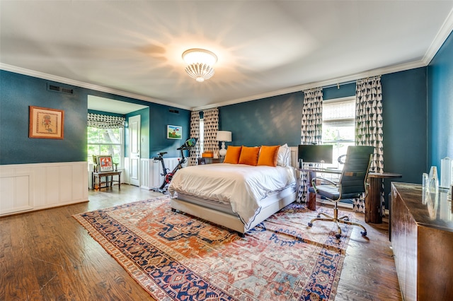 bedroom with hardwood / wood-style flooring and crown molding