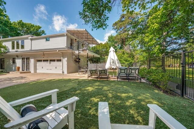 view of yard featuring a garage and a patio area