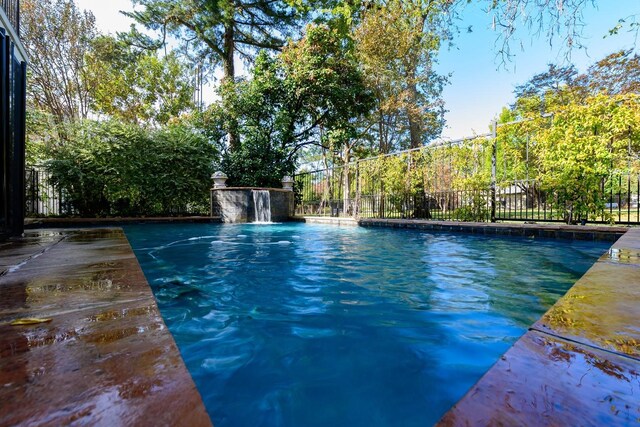 view of pool with pool water feature