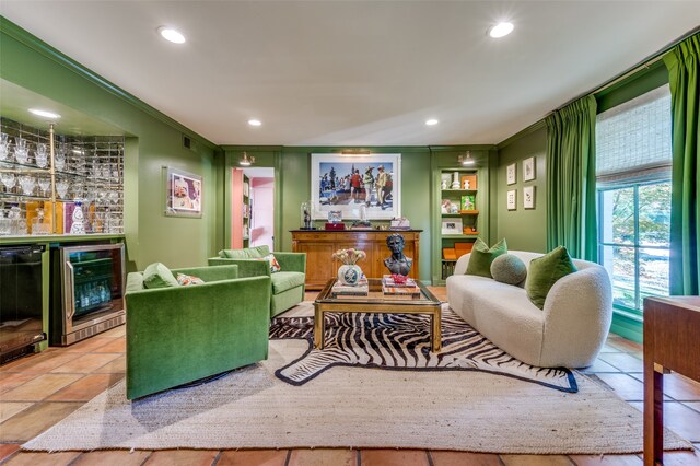 living room featuring beverage cooler, ornamental molding, and indoor bar