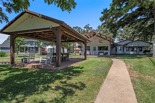 view of property's community with a gazebo, a patio area, and a yard