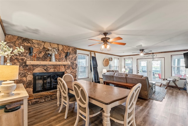 dining room featuring a fireplace, ceiling fan, crown molding, and dark hardwood / wood-style floors