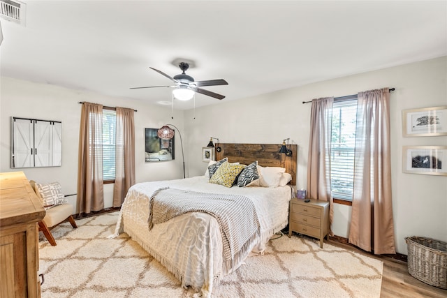 bedroom with ceiling fan and light wood-type flooring