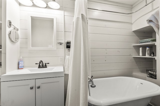 bathroom featuring wood walls and vanity