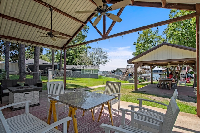 exterior space featuring an outdoor fire pit, a gazebo, a yard, ceiling fan, and a patio