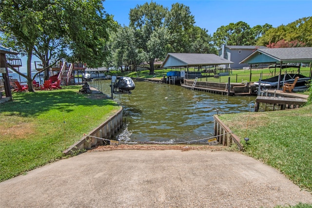 dock area featuring a lawn and a water view