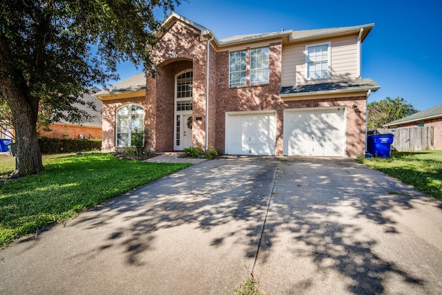 view of front of property featuring a garage and a front lawn