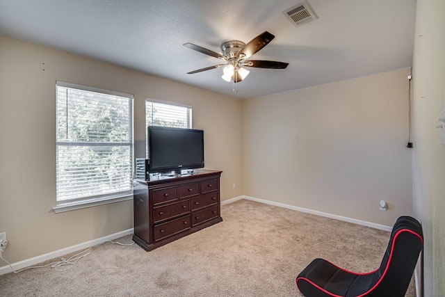 sitting room featuring ceiling fan and light carpet