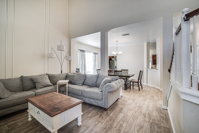 living room featuring a notable chandelier and wood-type flooring