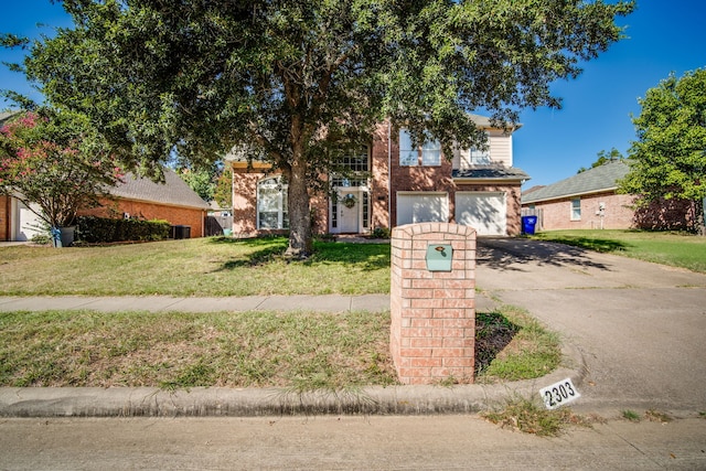 view of front of property featuring a garage and a front lawn