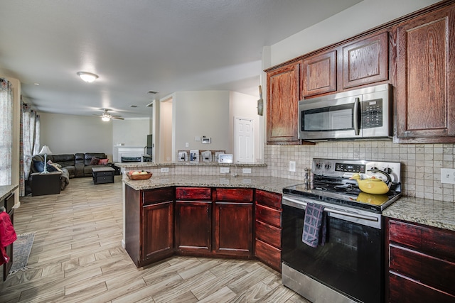 kitchen with ceiling fan, decorative backsplash, appliances with stainless steel finishes, and light stone counters