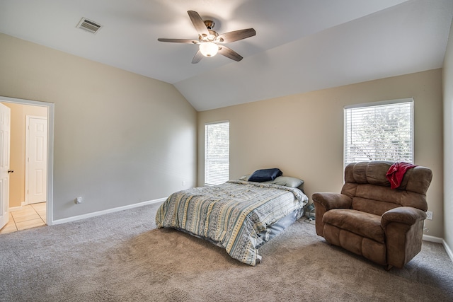 bedroom with ceiling fan, vaulted ceiling, and light colored carpet