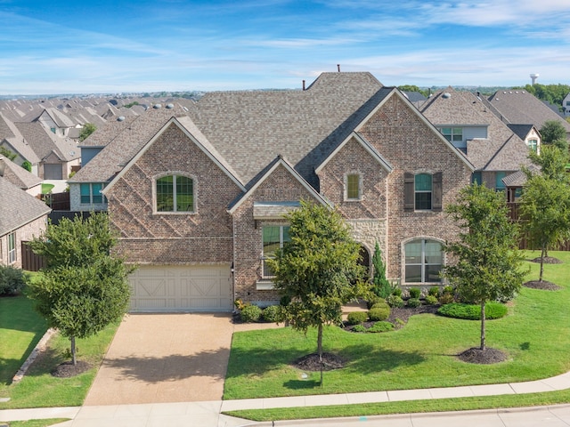 view of front of house with a front yard and a garage