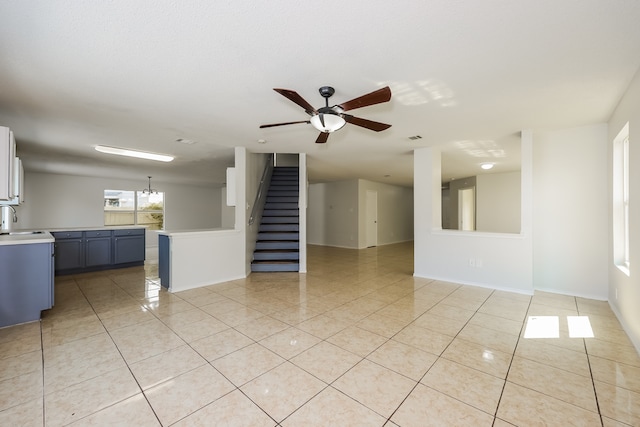 tiled spare room featuring ceiling fan and sink