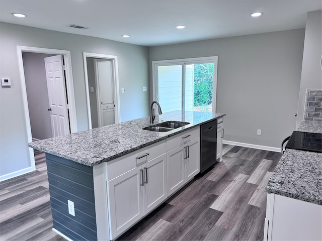 kitchen with white cabinetry, sink, black appliances, dark hardwood / wood-style floors, and an island with sink