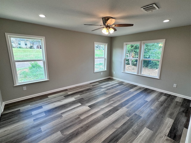 empty room with ceiling fan and dark hardwood / wood-style flooring