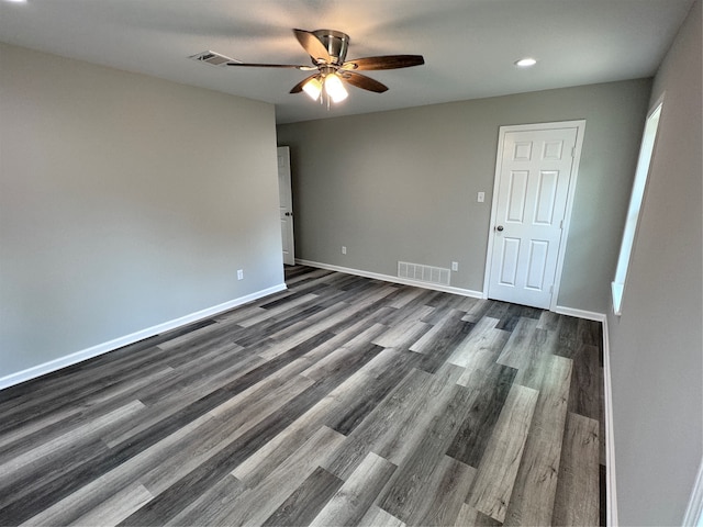 unfurnished room featuring ceiling fan and dark hardwood / wood-style floors