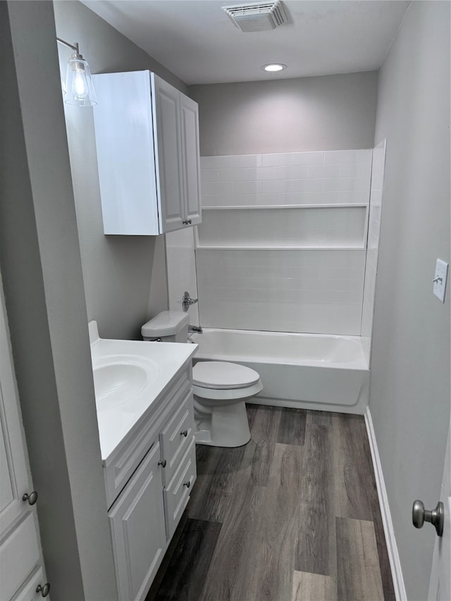 full bathroom featuring vanity, toilet, washtub / shower combination, and hardwood / wood-style flooring