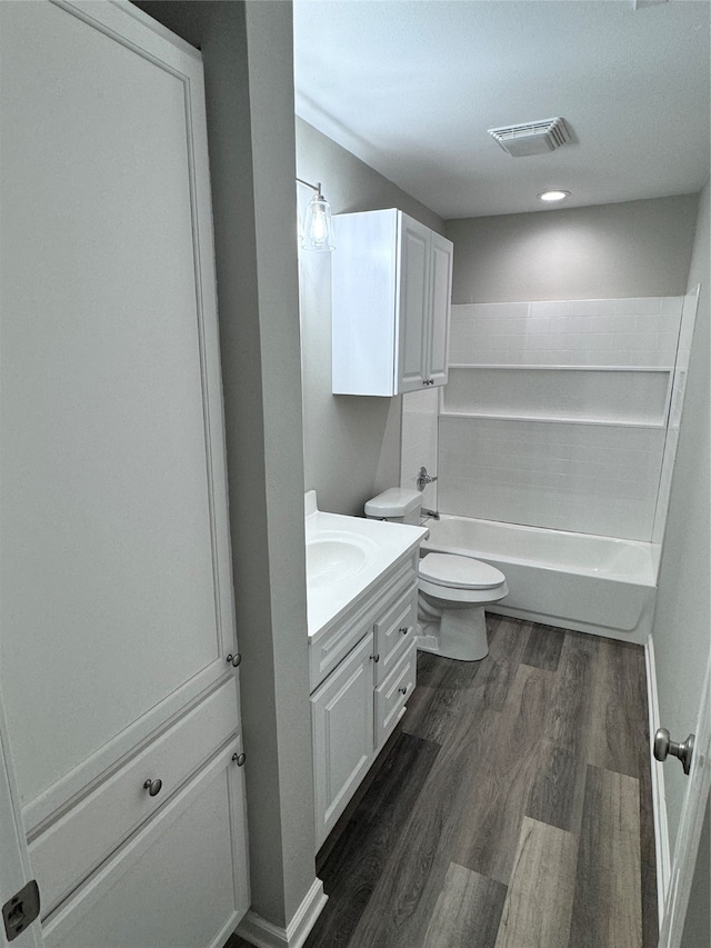 full bathroom featuring toilet, hardwood / wood-style flooring, bathing tub / shower combination, and vanity