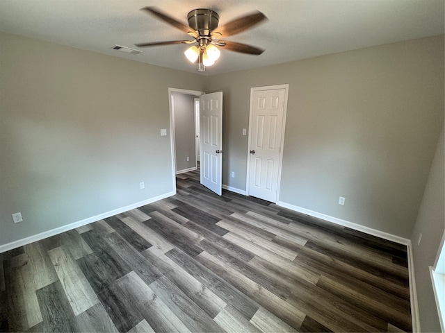 unfurnished bedroom with ceiling fan and dark hardwood / wood-style flooring