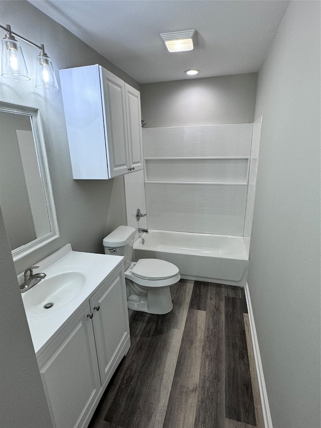 full bathroom with vanity, toilet, hardwood / wood-style floors, and tub / shower combination