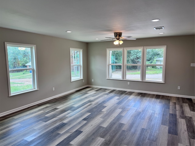 empty room featuring dark hardwood / wood-style flooring and ceiling fan