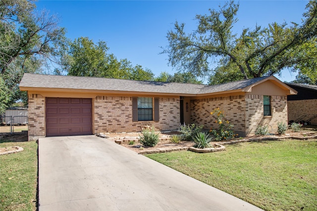 ranch-style house featuring a front lawn and a garage