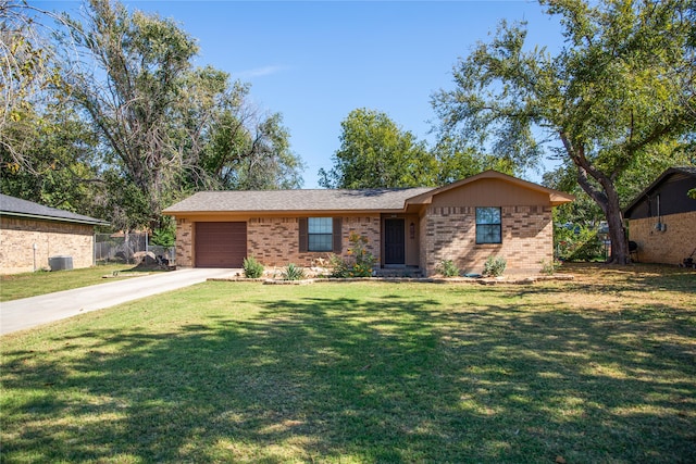 ranch-style home featuring a front yard, a garage, and central AC unit