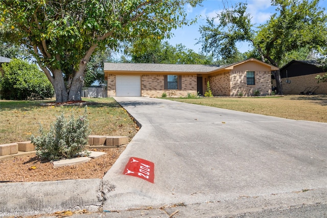 single story home with a front lawn and a garage