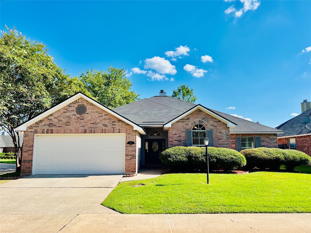 single story home with a front lawn and a garage