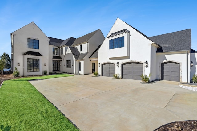 view of front of house with a front yard and a garage