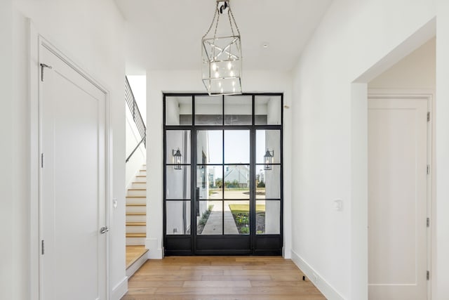 entrance foyer featuring a notable chandelier and light hardwood / wood-style flooring