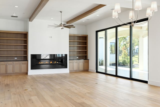 unfurnished living room with ceiling fan, beamed ceiling, and light hardwood / wood-style floors