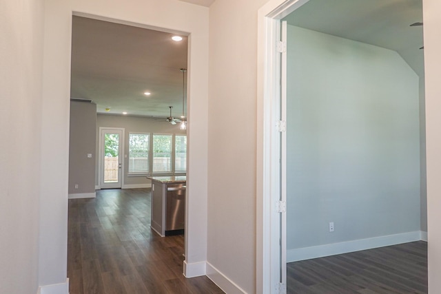 hall featuring recessed lighting, baseboards, and dark wood-type flooring
