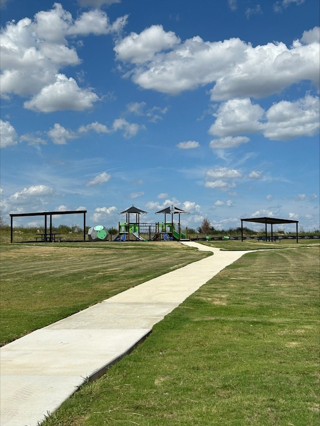 surrounding community with a yard and a playground