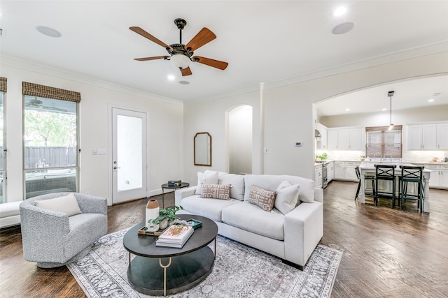 living room with ceiling fan, hardwood / wood-style flooring, and crown molding