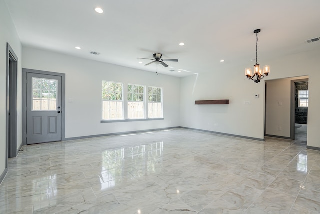 unfurnished living room with visible vents, marble finish floor, a wealth of natural light, and ceiling fan with notable chandelier