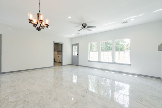 spare room featuring ceiling fan with notable chandelier, baseboards, visible vents, and recessed lighting