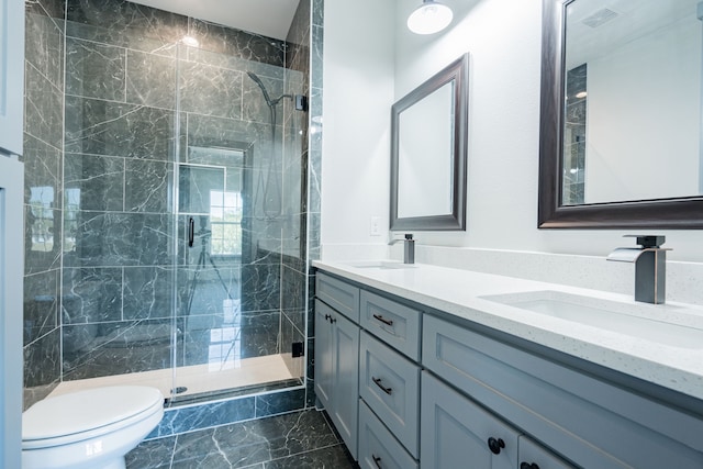 bathroom with walk in shower, vanity, and toilet