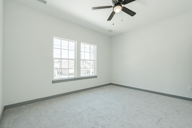 spare room featuring carpet floors, baseboards, and ceiling fan