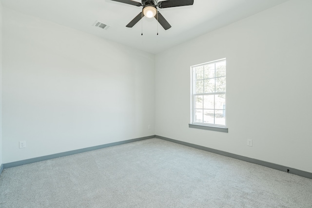 carpeted empty room featuring ceiling fan