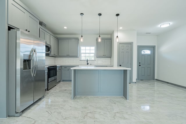 kitchen with light countertops, marble finish floor, appliances with stainless steel finishes, and gray cabinets