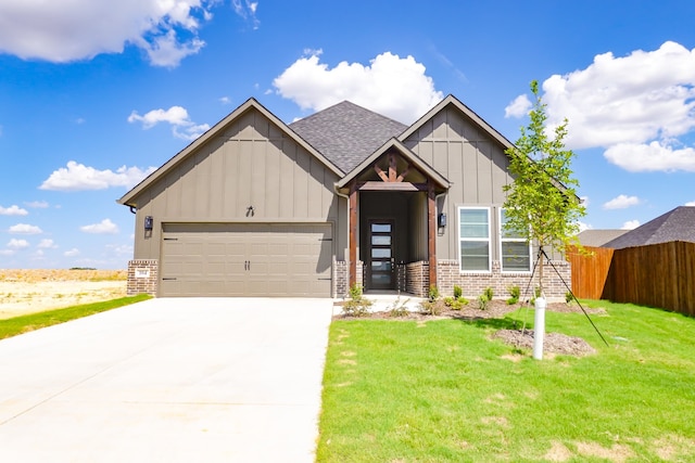 craftsman-style home featuring a garage and a front lawn